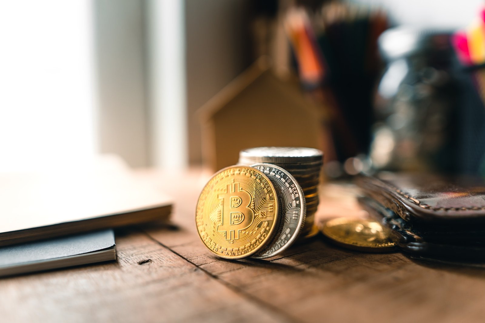 Bitcoin coins on a wooden desk at home