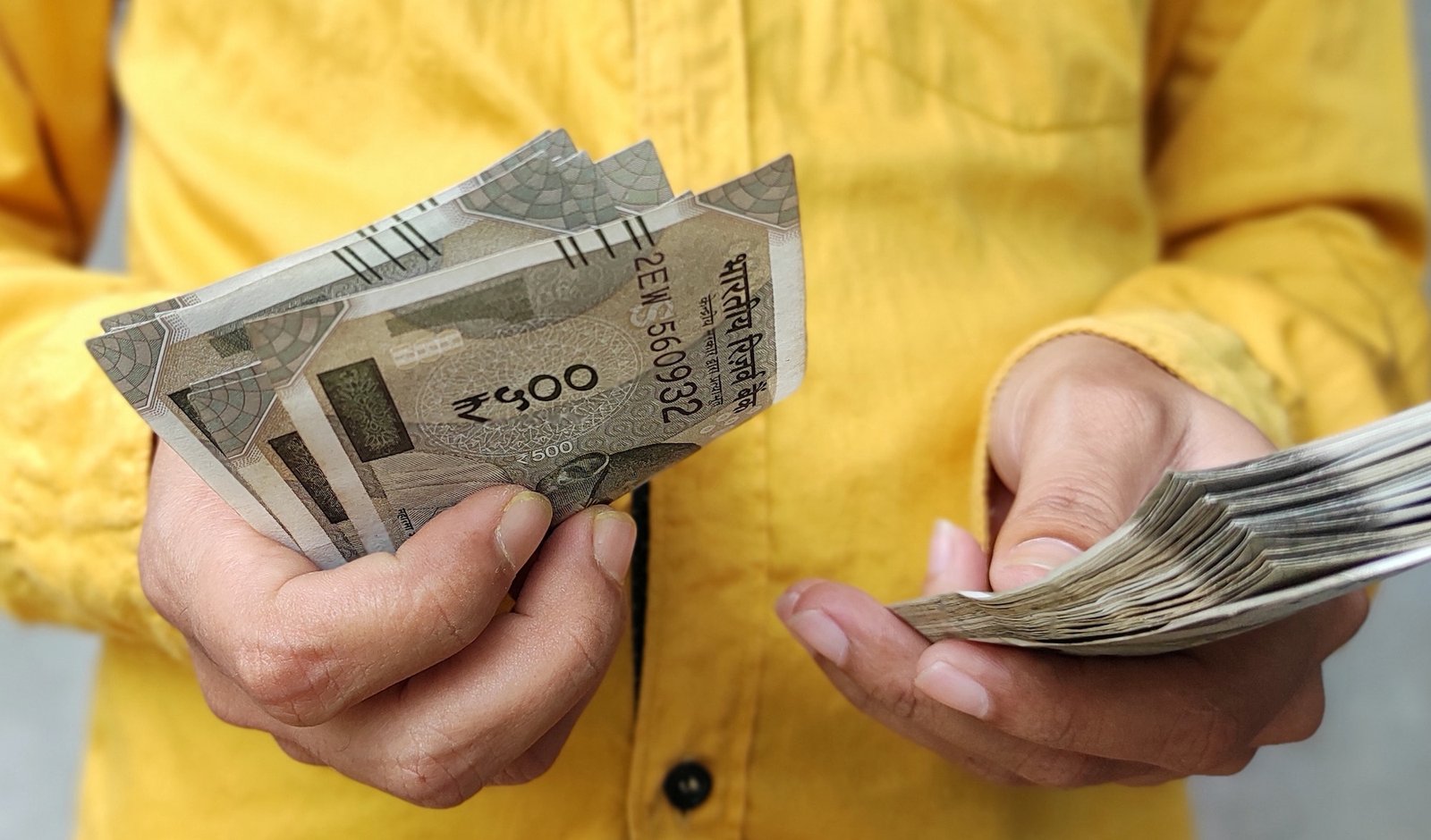 Holding money in hand, counting Indian currency 500 rupee note in hand, business , financial